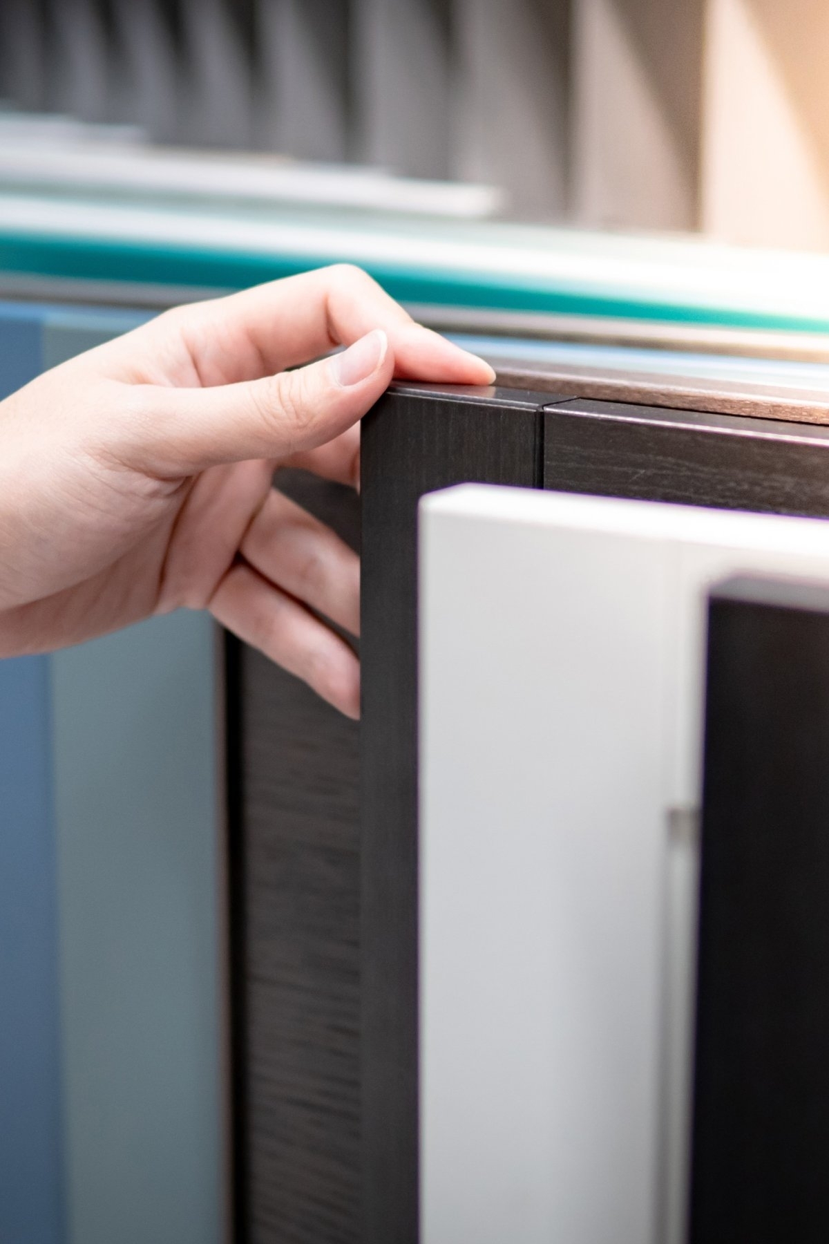 image showing hand of a person who is choosing among different styles for cabinet doors