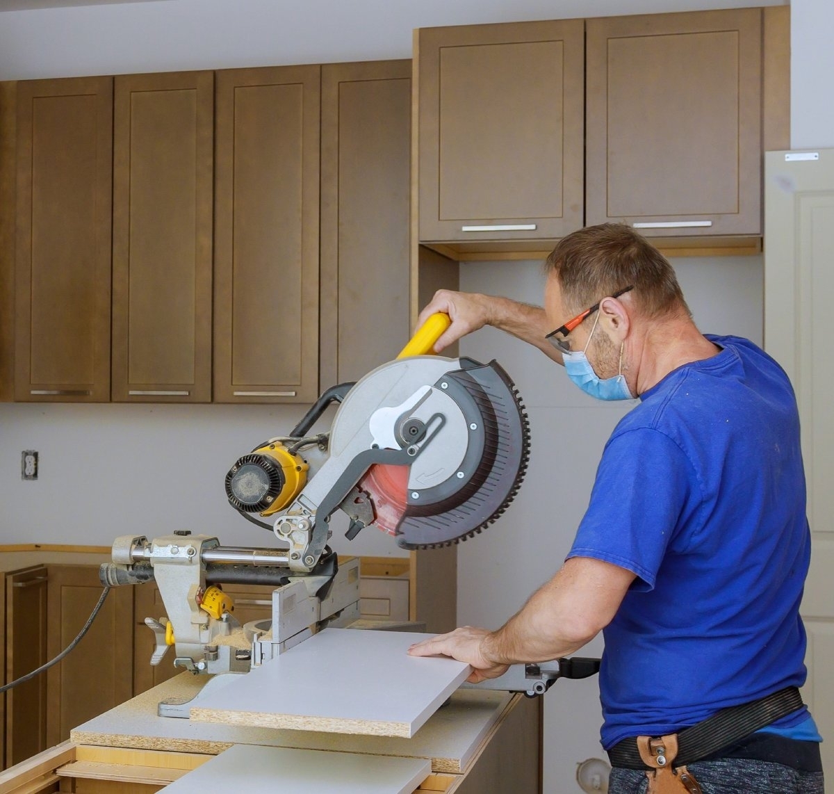 image showing a man installing new cabinet doors