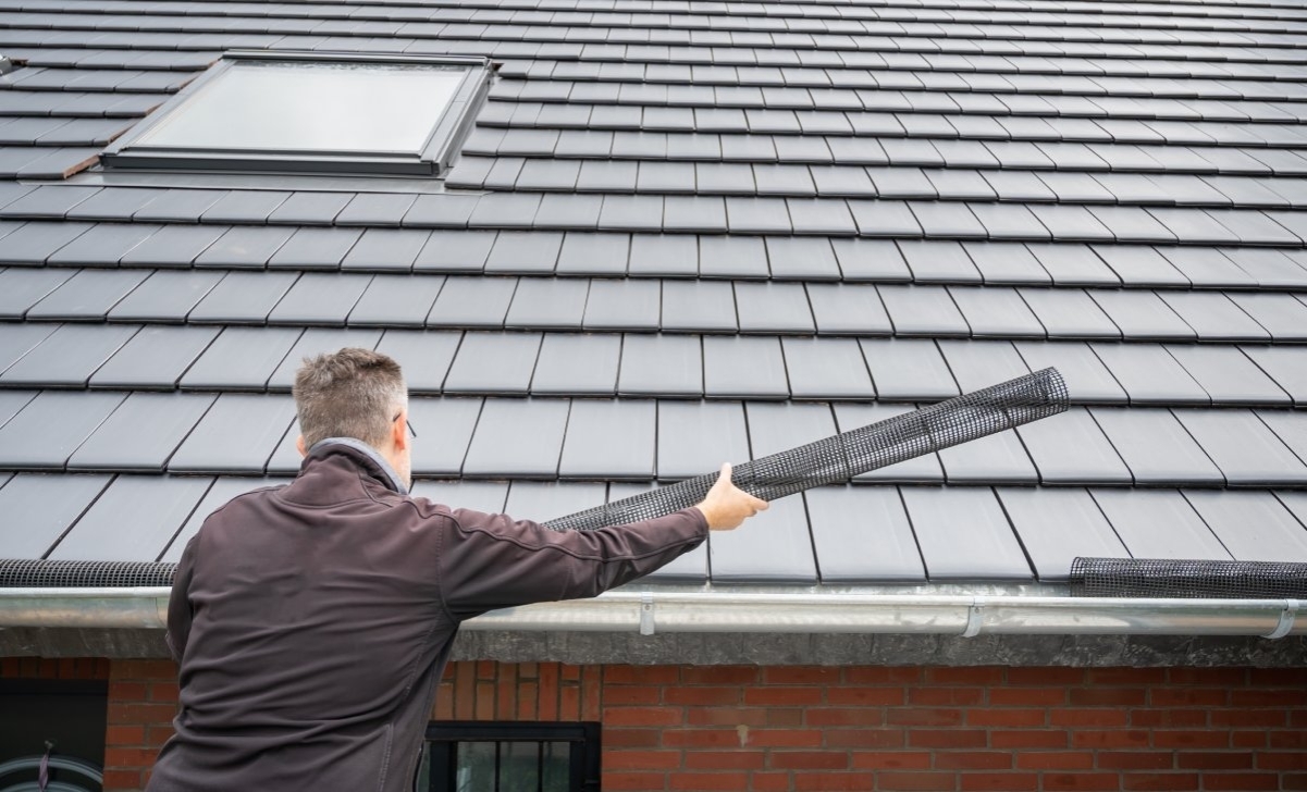 image showing a professional installing a gutter guard