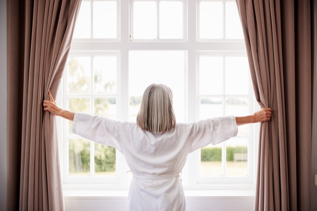 image showing senior in front of a window