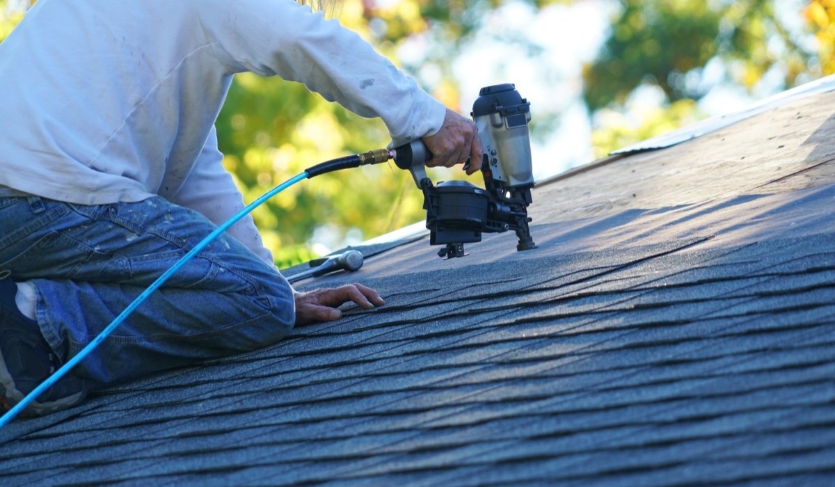 image showing person performing roofing maintenance
