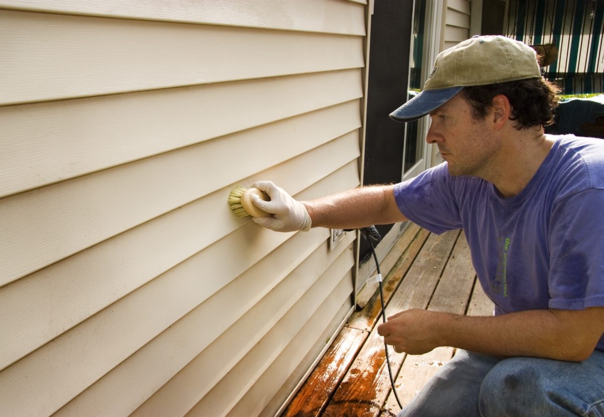 image showing professional working on vinyl siding