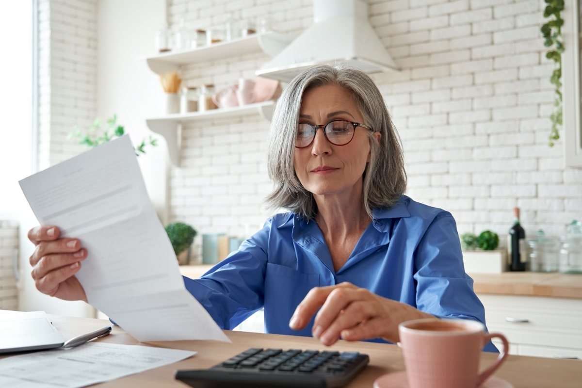 image showing woman looking at house costs of maintenance worried