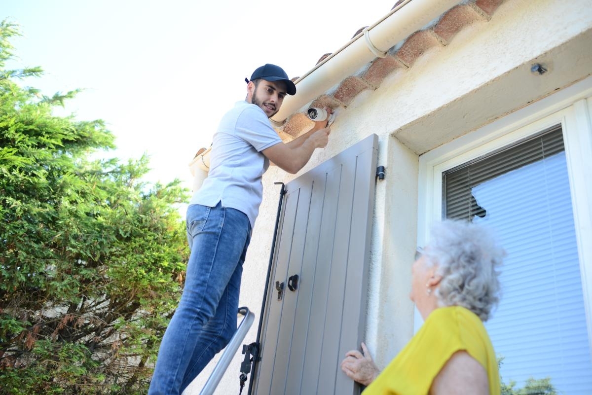 image showing professional installing security camera outdoor