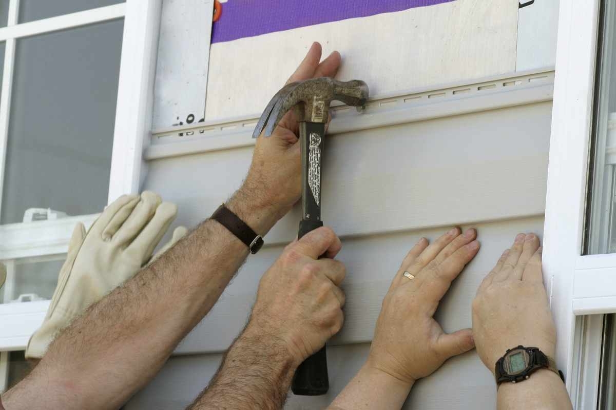image showing helping hands replacing siding