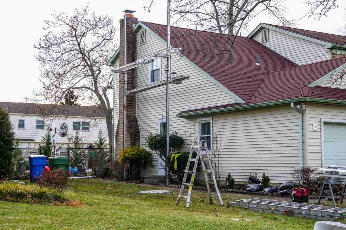 image showing a house with siding under maintenance