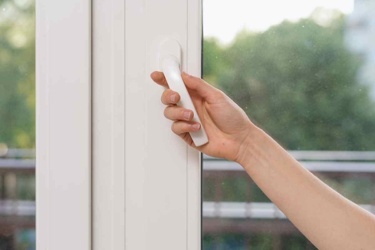 image showing hand closing window