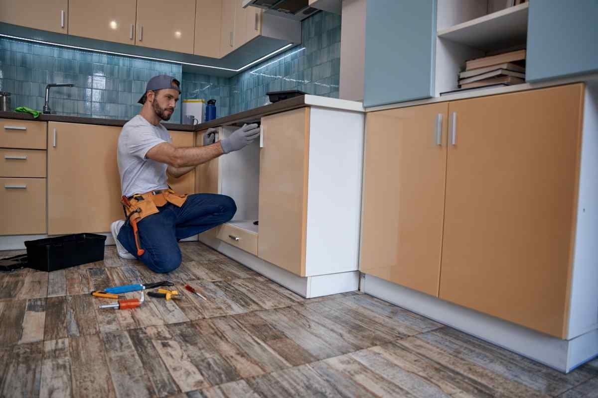image showing an expert in kitchen remodeling while revising a kitchen
