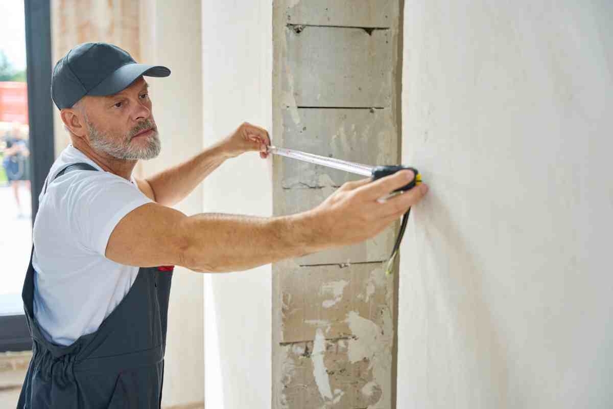 image showing professional siding supplier measuring wall