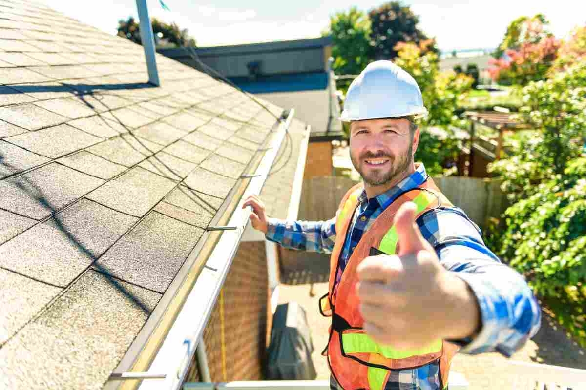 image showing gutter guard supplier smiling at camera with thumb up