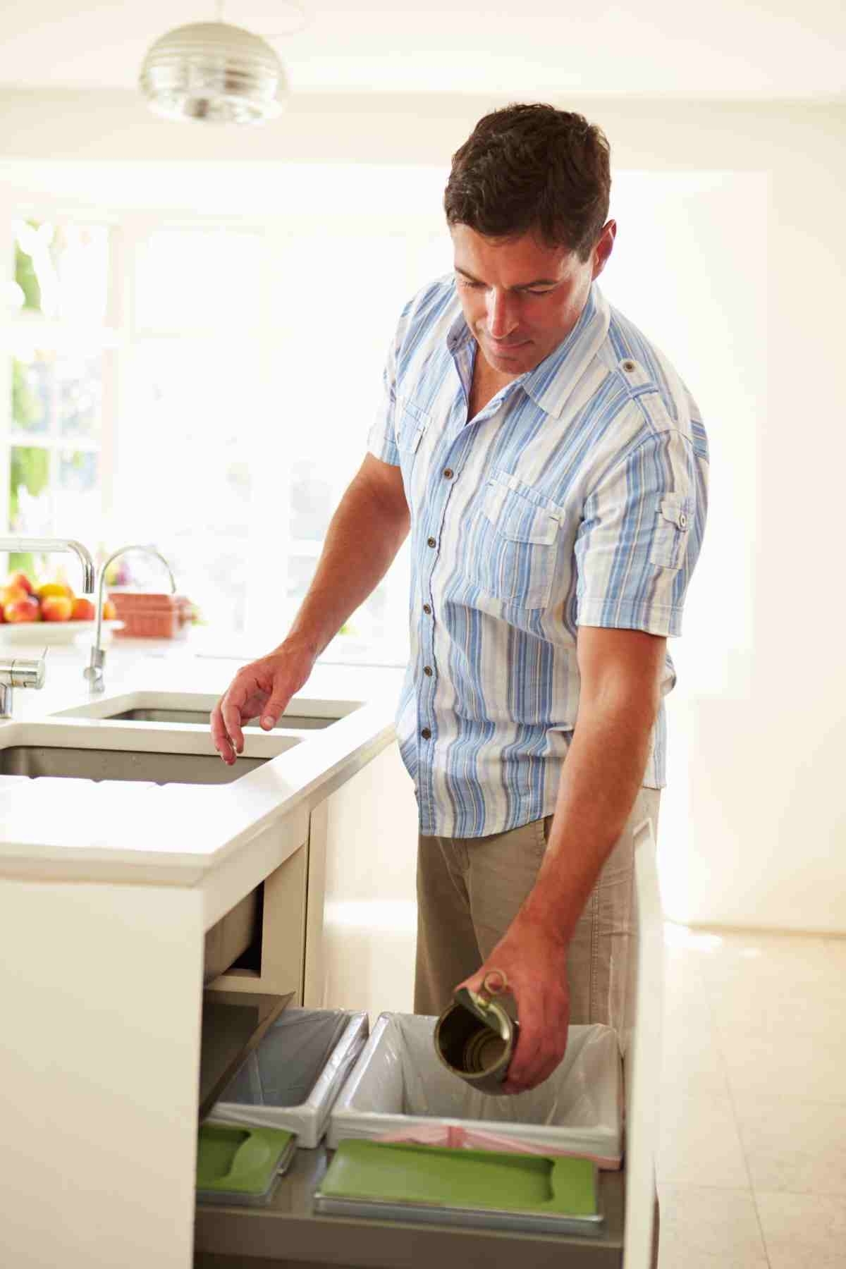 image showing man recycling in his own kitchen