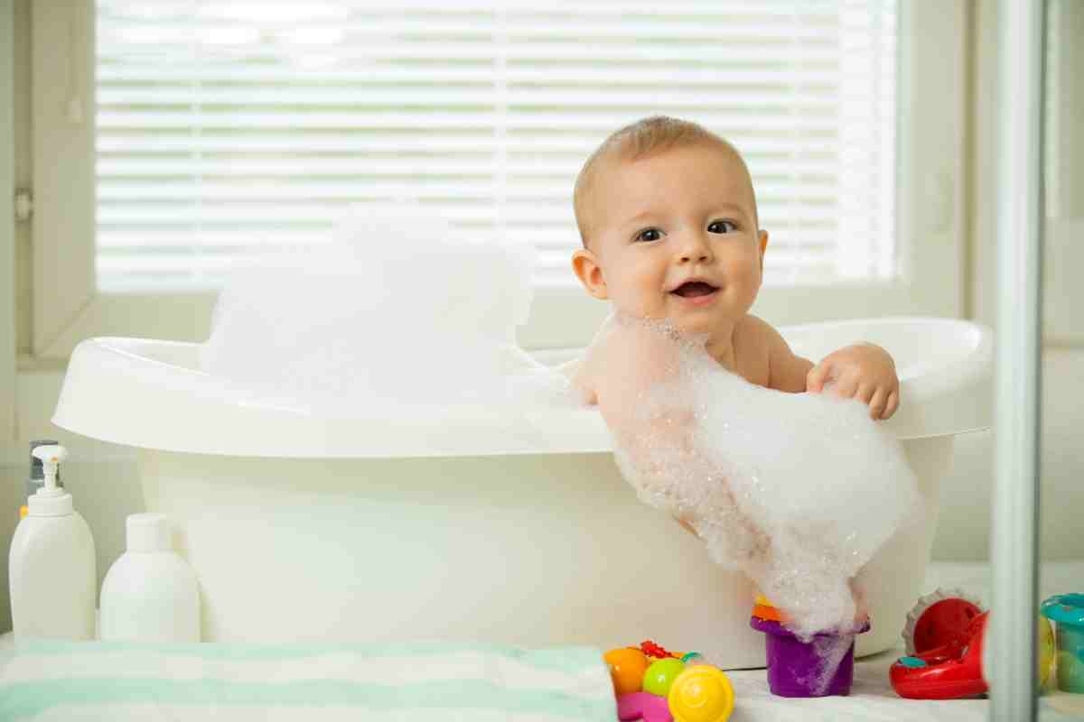 image showing toddler bathing in a small tub