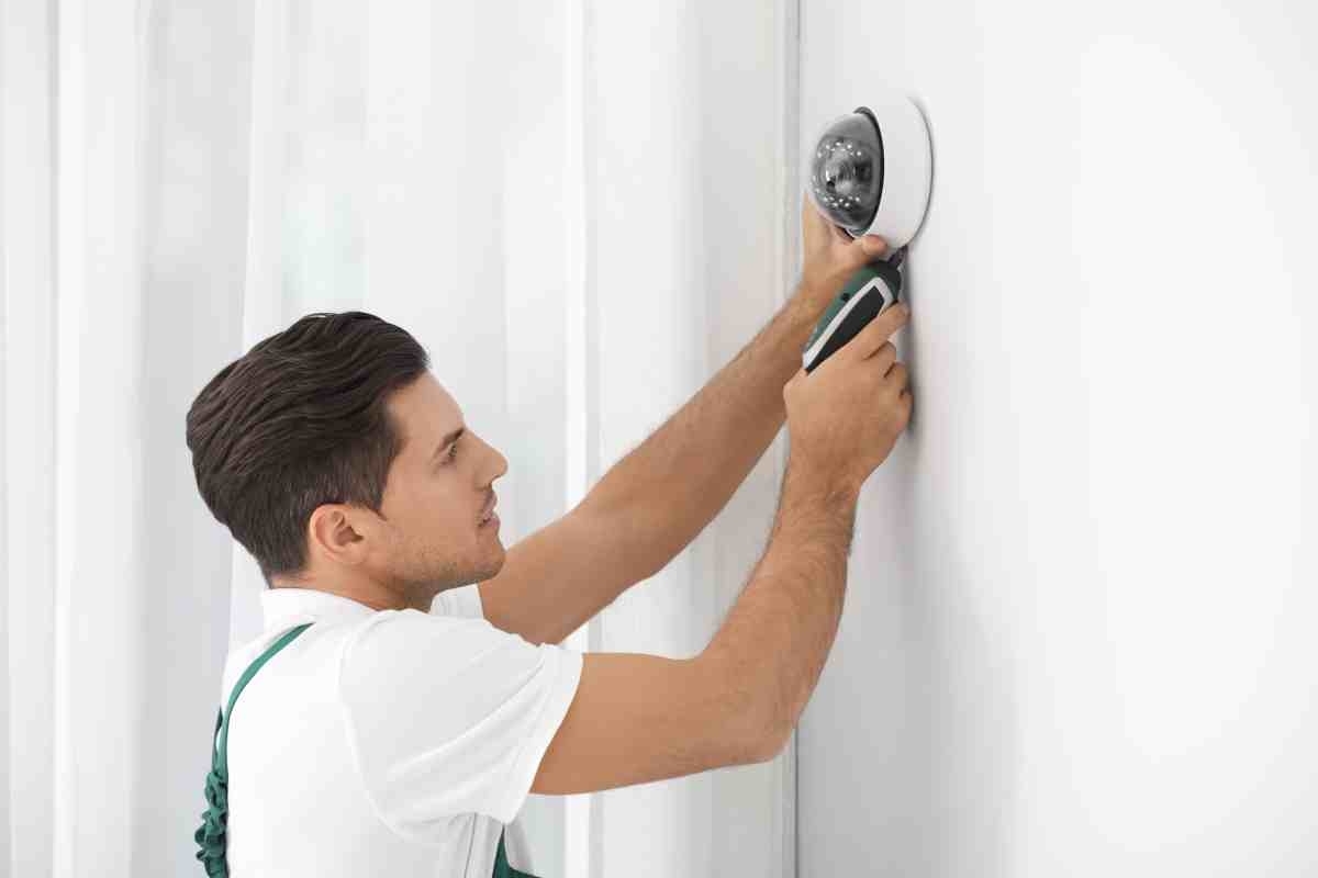 image showing professional installing home security system