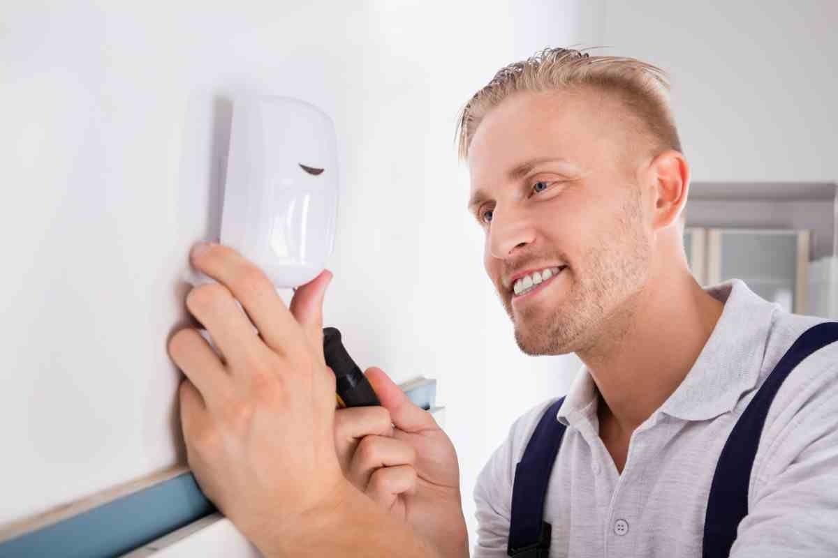 image showing man installing motion sensors for home security system