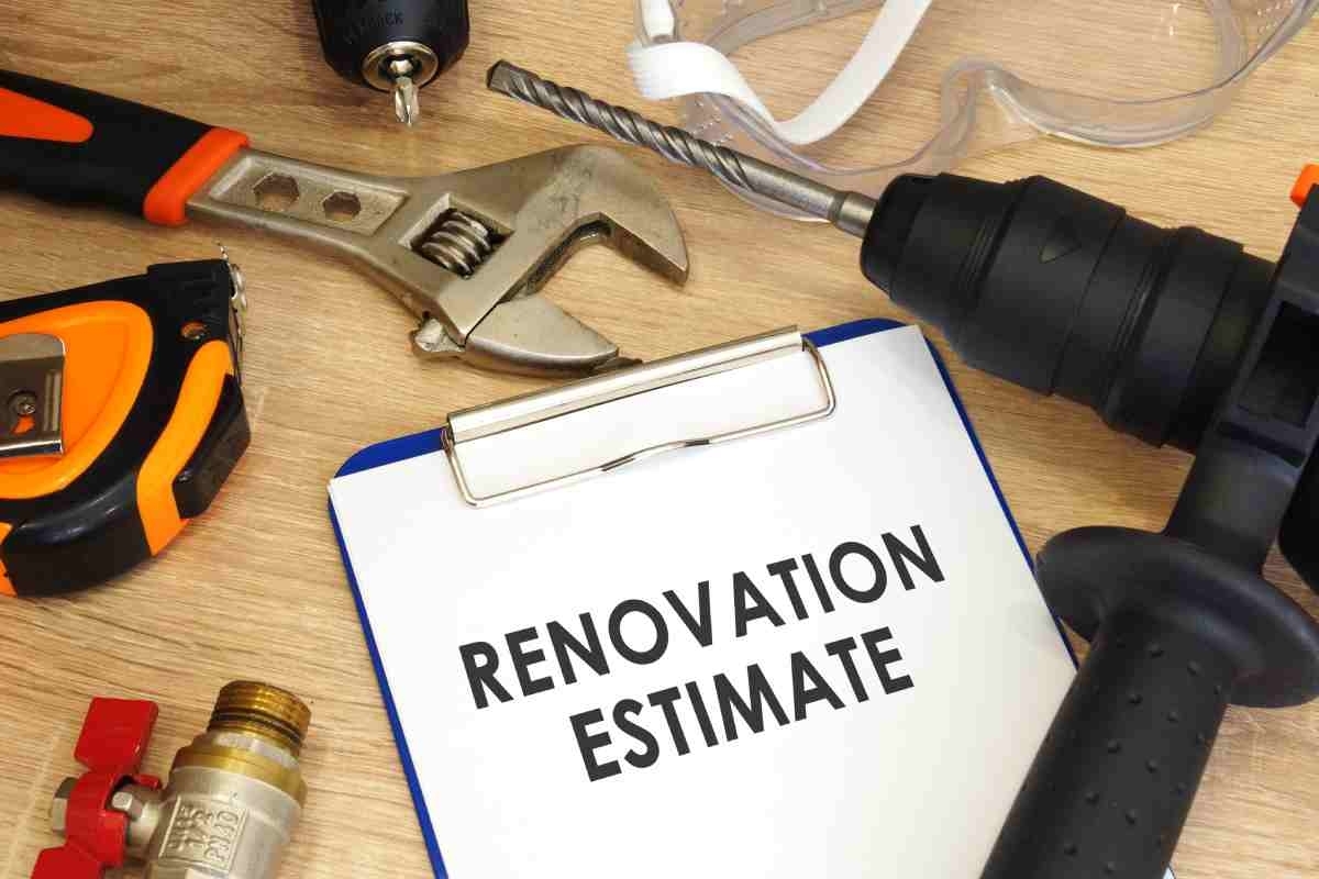image showing table with tools for home remodeling, papers, and a full home renovation estimate of costs
