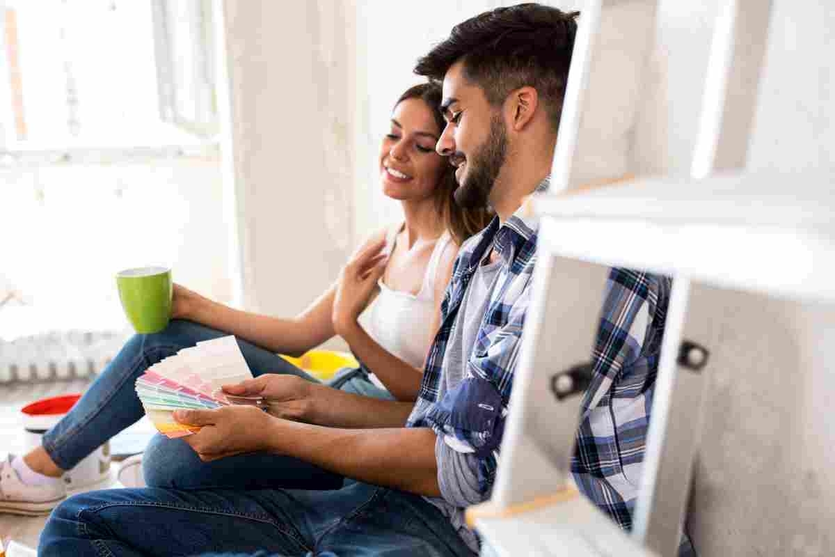 image showing a happy couple while looking at options for their remodeling while sitting on the floor close to the sofa