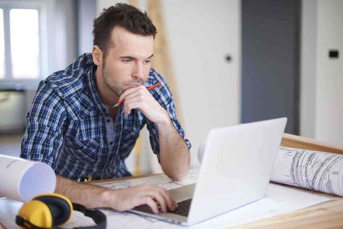 image showing homeowner looking at his computer screen with concerned look