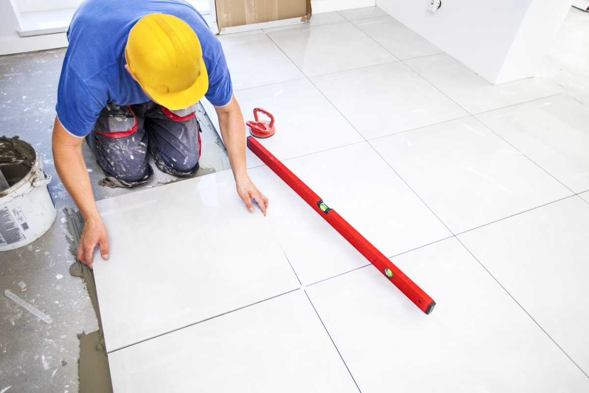 image of contractor changing the flooring of a bathroom