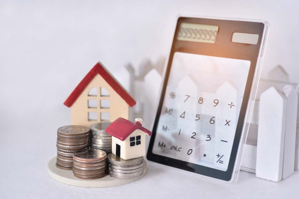 image showing calculator, small house and some coins