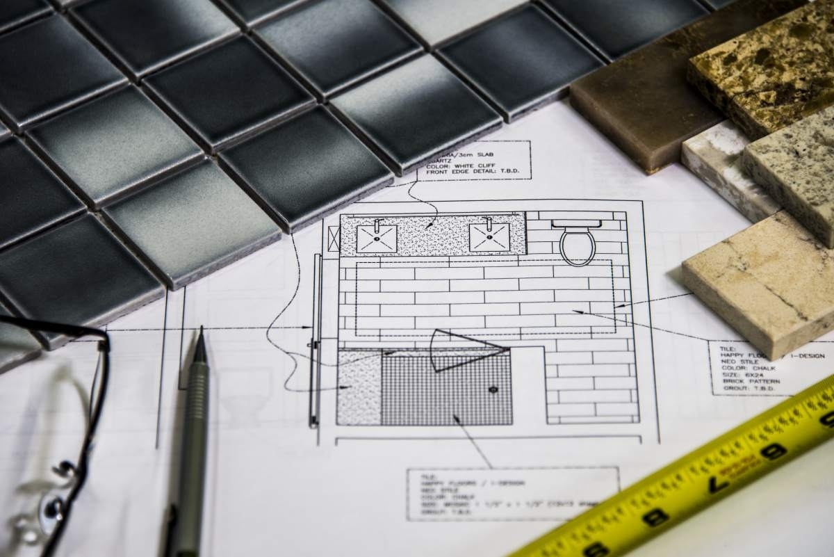 image showing a drawing of a bathroom map, some tiles and tools for planning