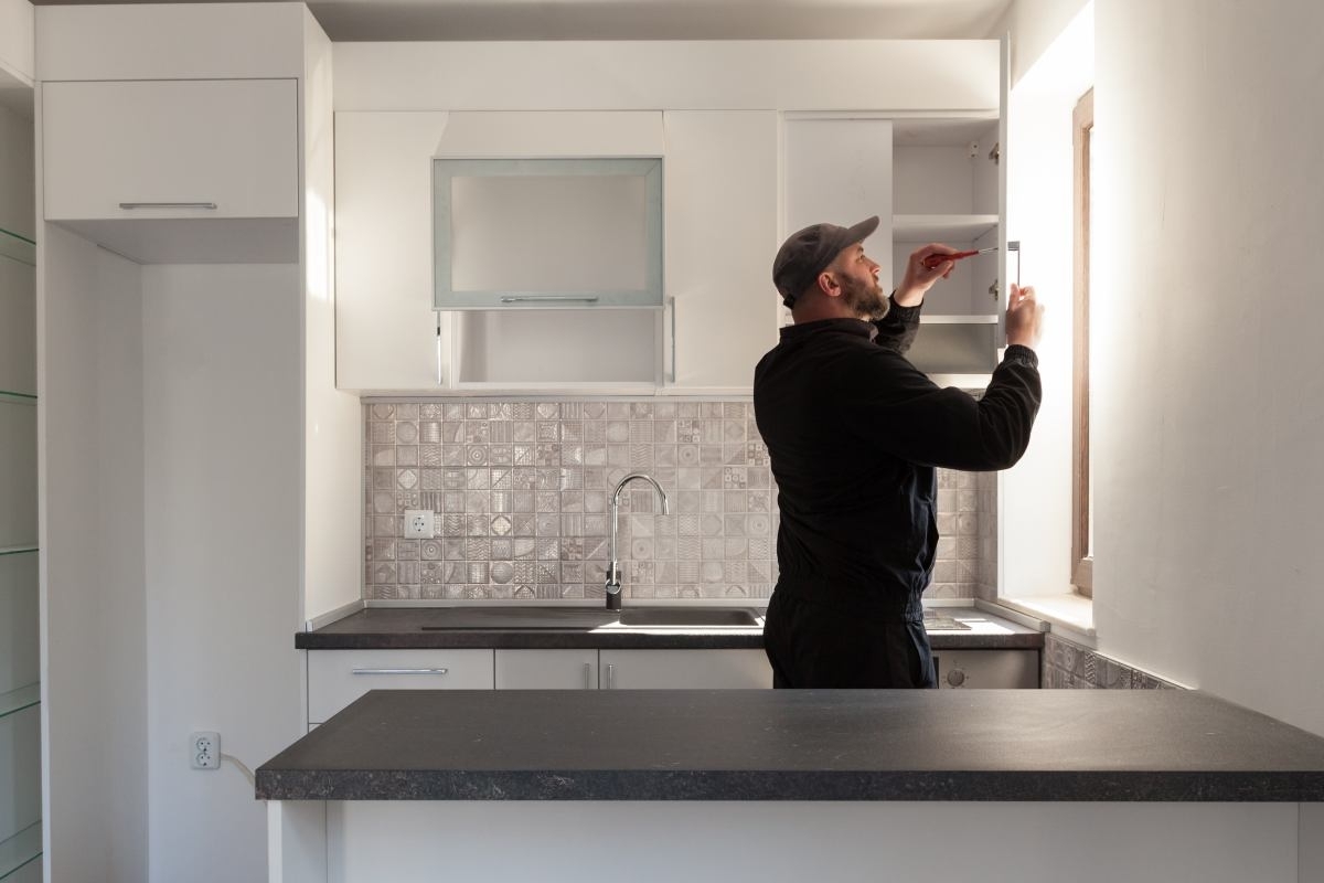 image showing a professional remodeling a kitchen