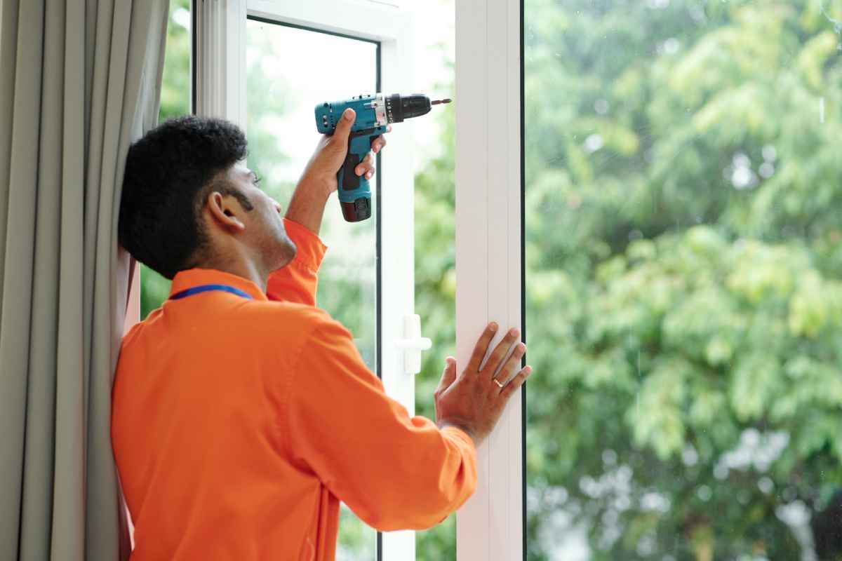 image showing a professional repairing a window