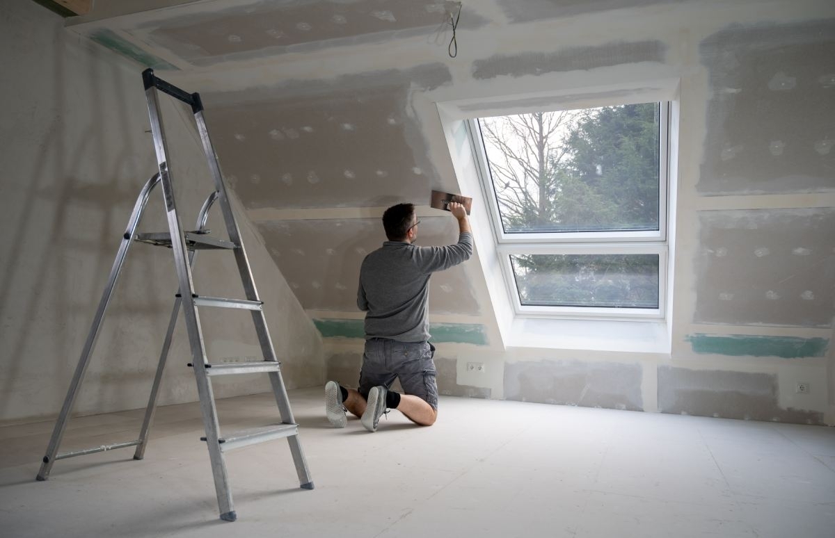image showing a man installing a new construction window