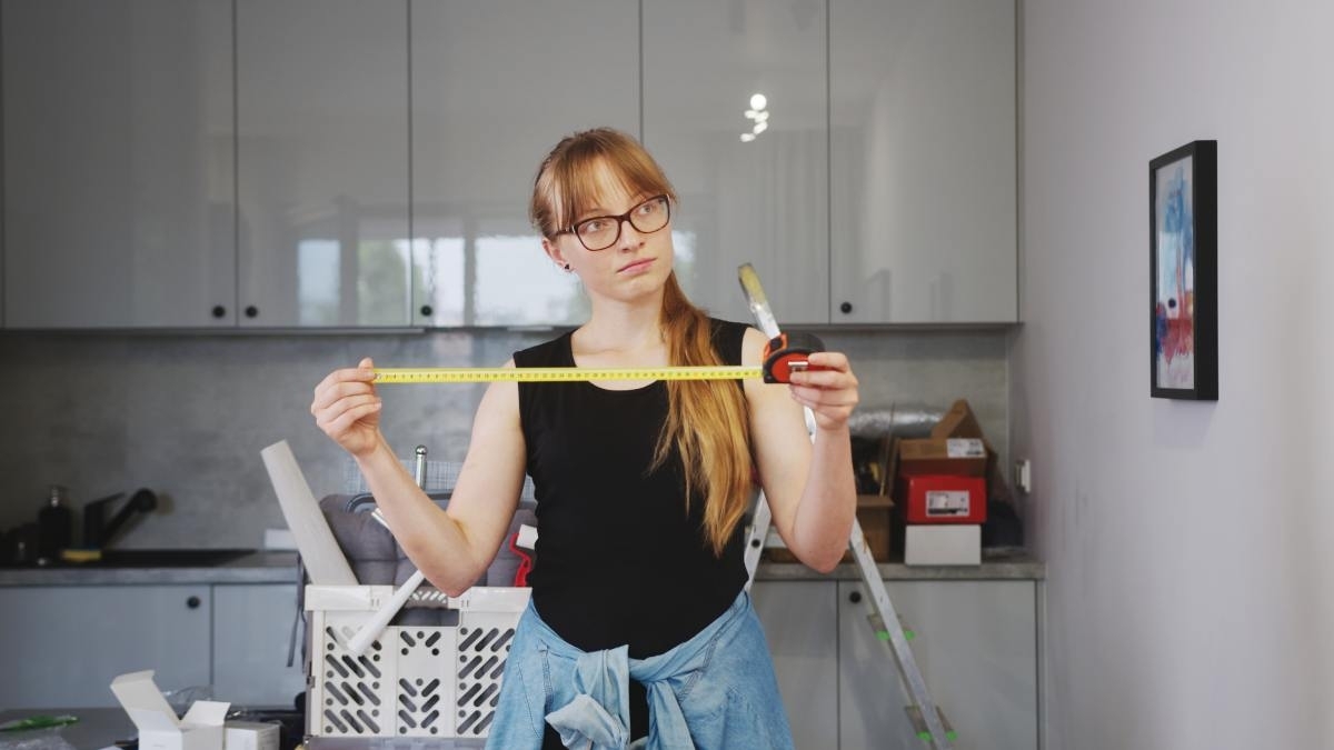 image showing a girl in a kitchen with some diy renovation tools