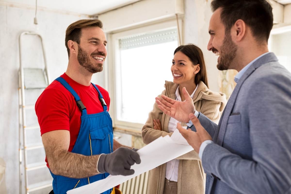 image showing a contractor shaking hands with a couple