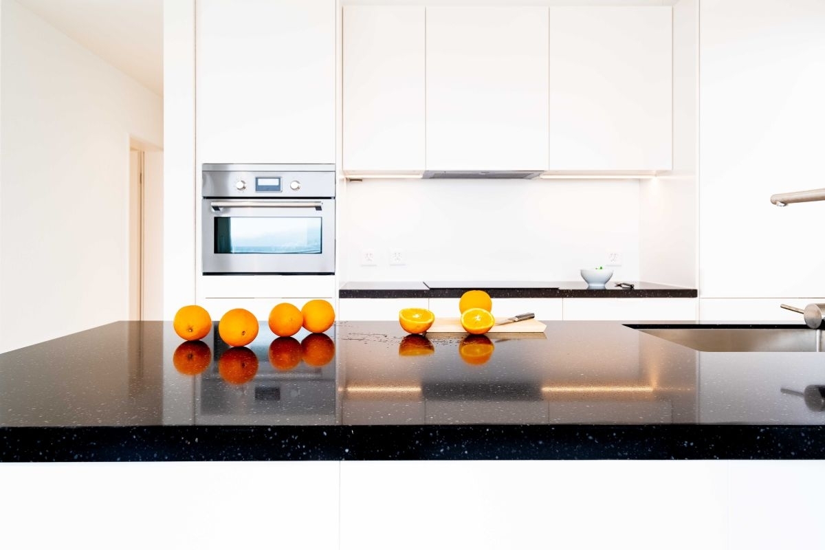 white kitchen cabinets with black countertops