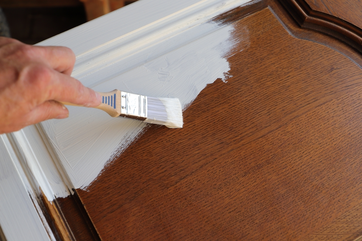 man painting kitchen cabinets