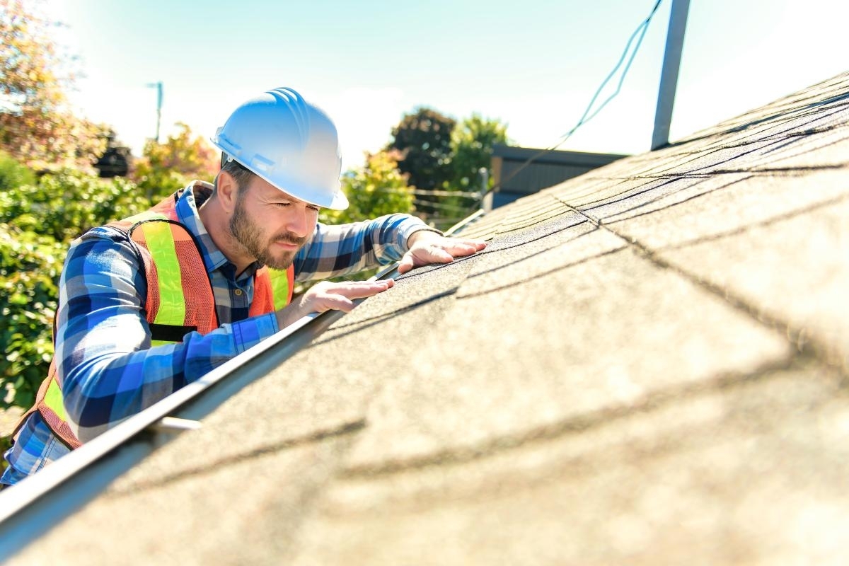 contractor looking at roof for replacement