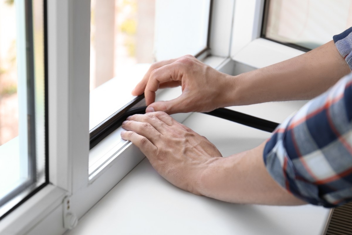 hands fixign window seal