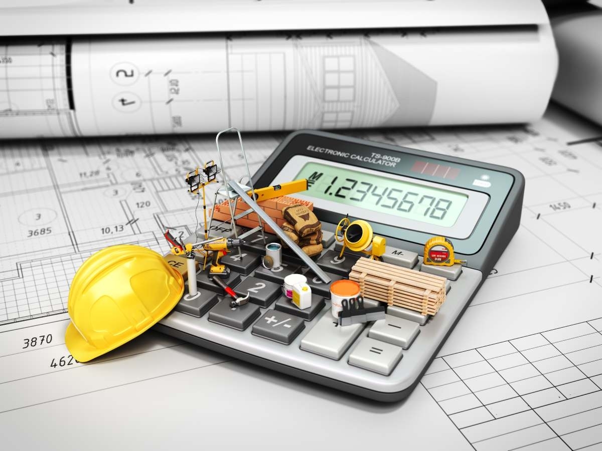 calculator and house remodeling tools on a house project paper