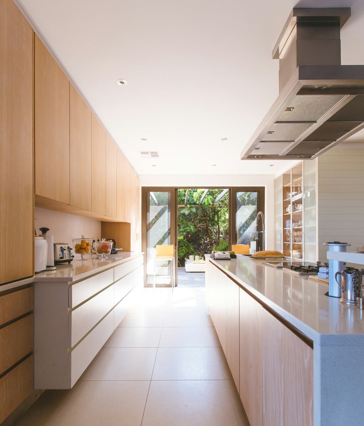 Eco-friendly wood kitchen with a garden view and open door.