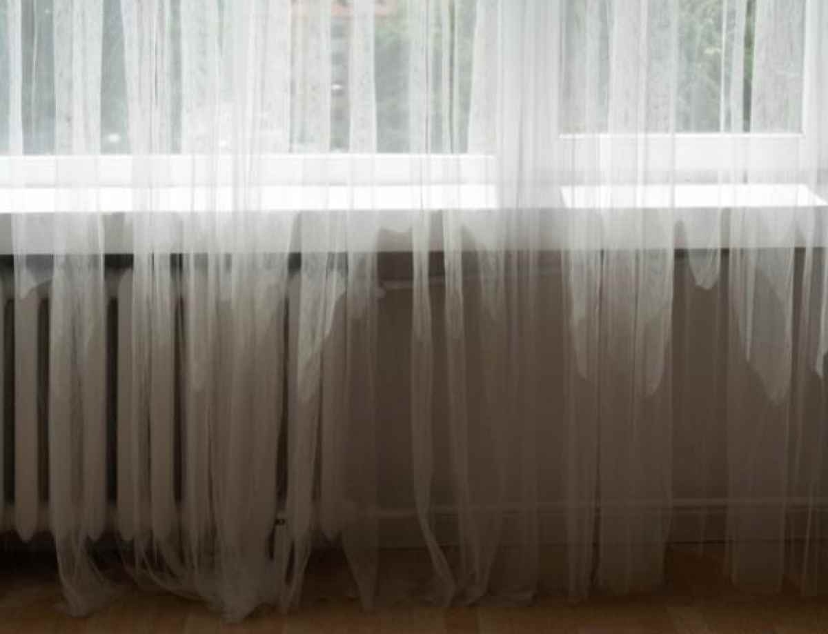 White sheer curtain (window treatment) filtering sunlight (home decor).