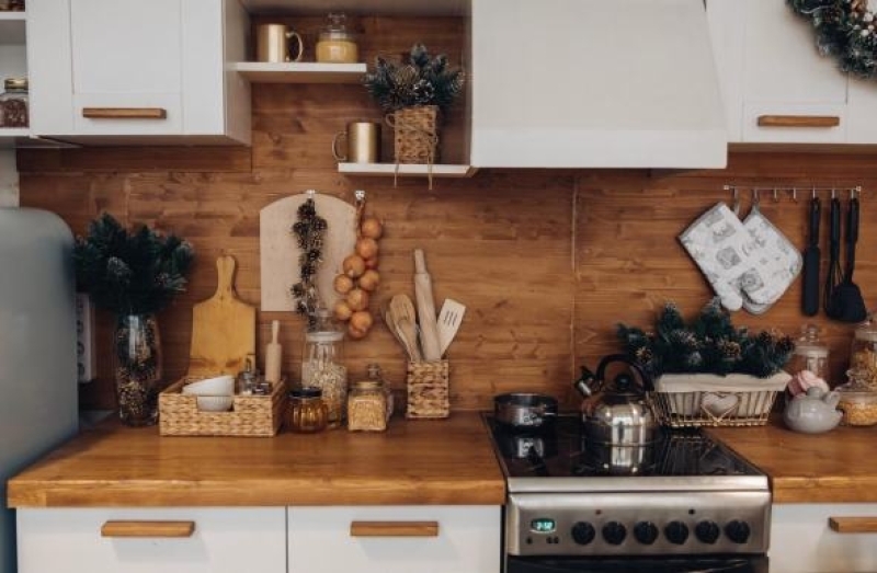 Wood-centric kitchen design with wooden cabinets, countertops, and cooking utensils.