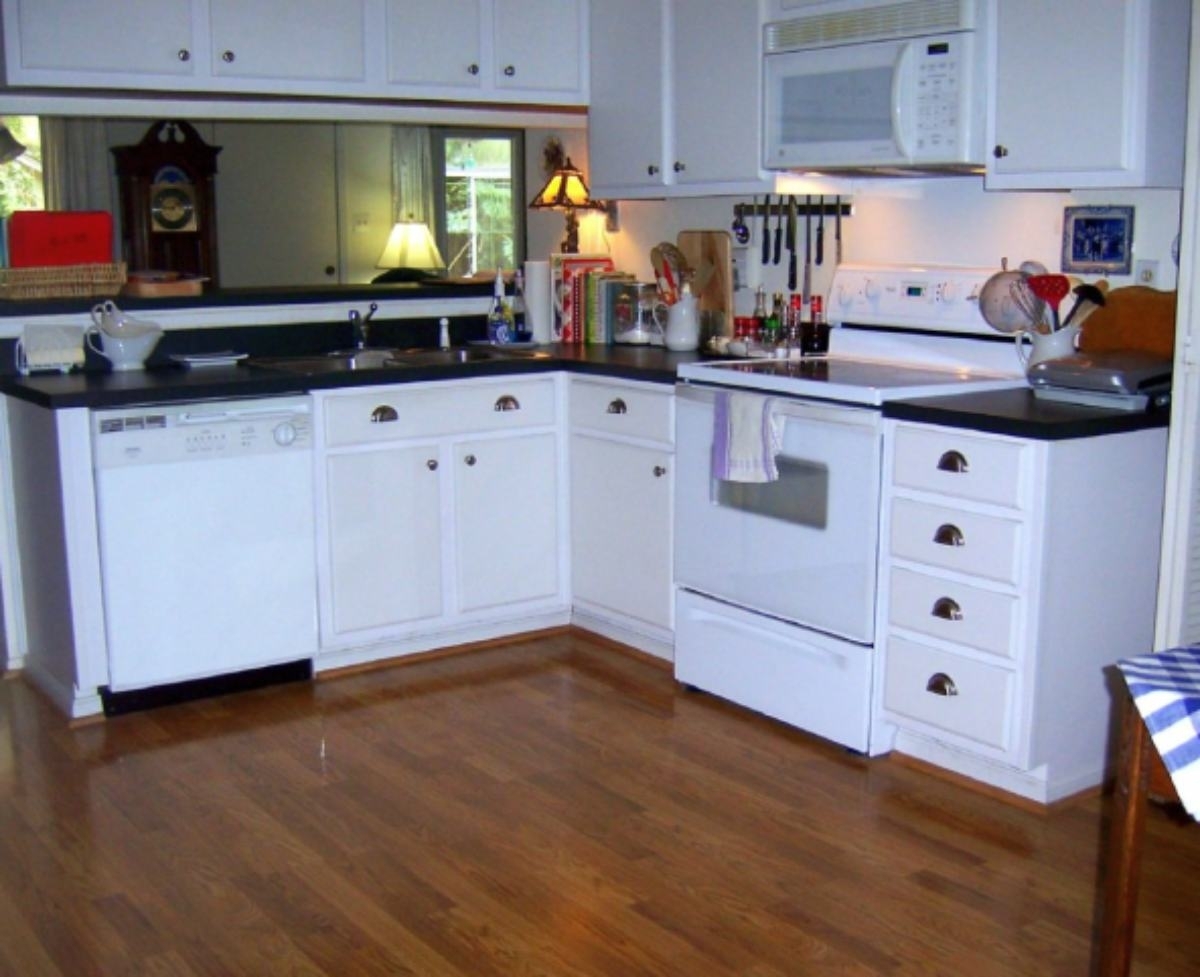 Classic kitchen with white cabinets and granite countertops.